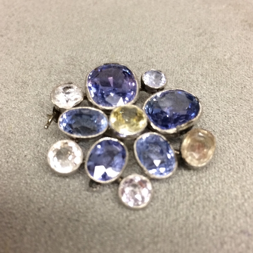 97 - Unmarked white metal sapphire and fancy sapphire  brooch 9.7g (some inclusions to one of the big blu... 