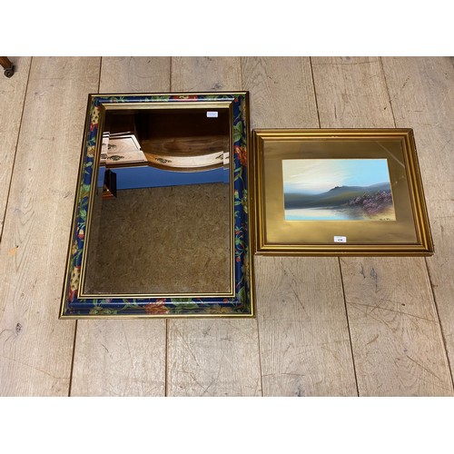 438 - A decorative mirror with hand painted floral and gold coloured border and a framed and glazed moorla... 