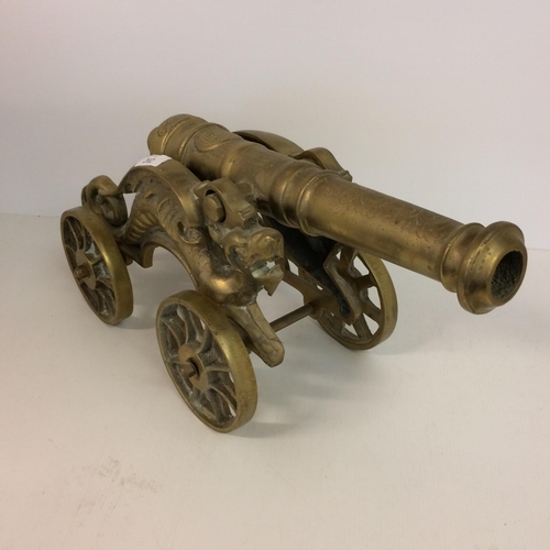 443 - A bronze cannon,  tip to tip 45cm, 23cm at highest point.