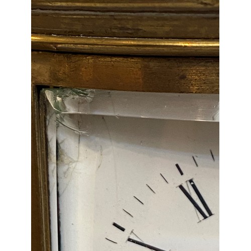 187 - French oval gilt brass four pane carriage clock, striking on a bell with key, losses to glass front ... 