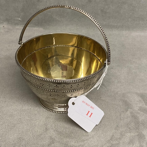 11 - A Victorian sterling silver bowl, swing handle with chased decoration, beaded rim and gilt interior ... 