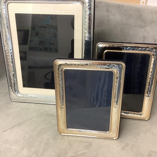 111 - Pair of Continental silver easel black picture frames and a single larger example, 14 x 19cm and 23 ... 