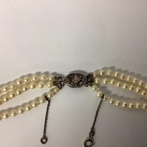 117 - A triple stand of pearls on a diamond set white metal clasp boxed. Largest pearl approx 6mm, approx ... 