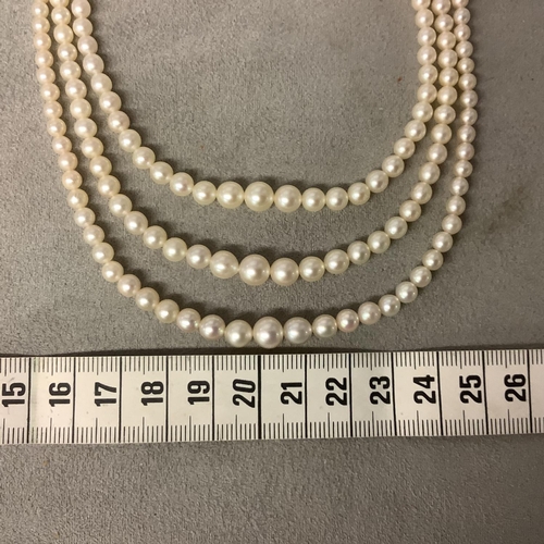 117 - A triple stand of pearls on a diamond set white metal clasp boxed. Largest pearl approx 6mm, approx ... 