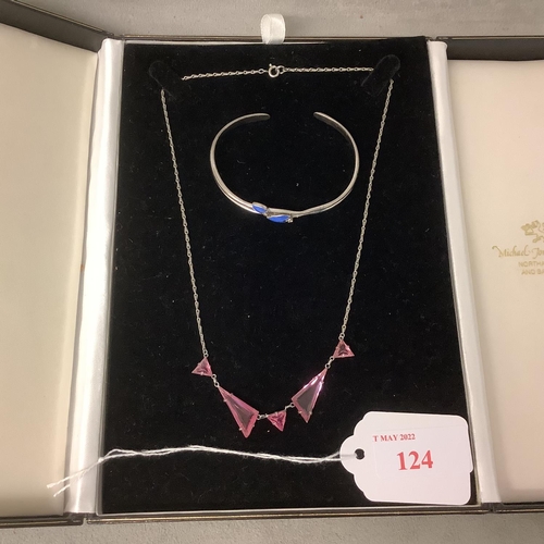 124 - A platinion and pink topaz necklace and a whie metal and enamel bangle bracelet, boxed