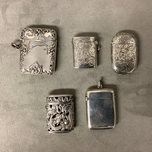 145 - Four Sterling silver vesta cases and an oriental unmarked white metal vesta case, various dates and ... 