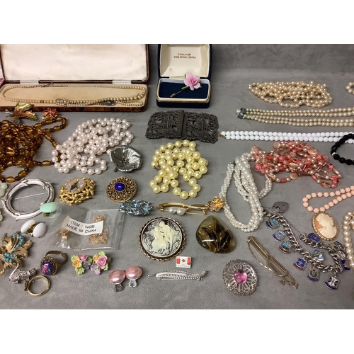 146 - Collectoin of costume jewellery to incluade a white nurses buckle and a sterling silver charm bracel... 