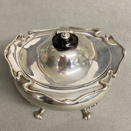 17 - An Edwardian Sterling silver tea caddy raised on for scrolling feet by Goldsmiths and Silversmiths C... 