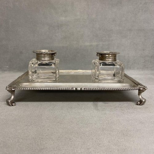 2 - A Sterling silver desk standish raised on four scrolling feet with original silver topped glass inkw... 