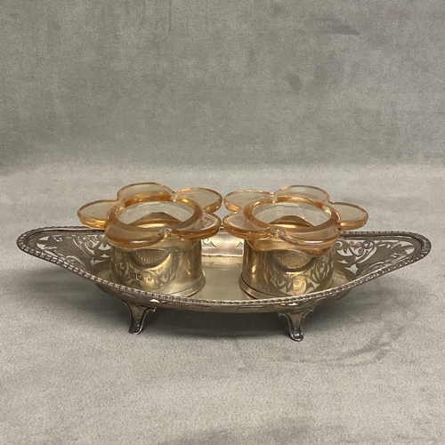 23 - A Sterling silver double desk inkwell, with two glass inserts on a pierced stand, raised on four fee... 