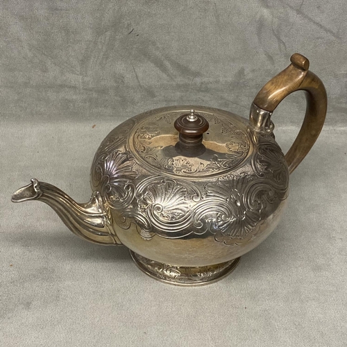 28 - A Georgian sterling silver teapot of bulbous form with chased decoration, fruitwood handle & finial,... 