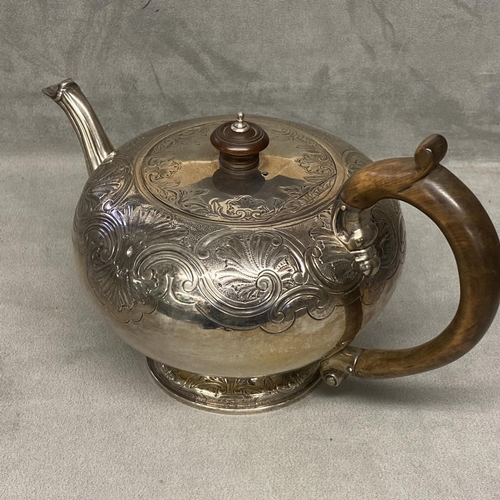 28 - A Georgian sterling silver teapot of bulbous form with chased decoration, fruitwood handle & finial,... 