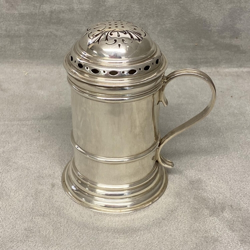 30 - A sterling silver sugar shaker of pillar form with loop handle, Sheffield 1934 by Thomas Bradbury & ... 