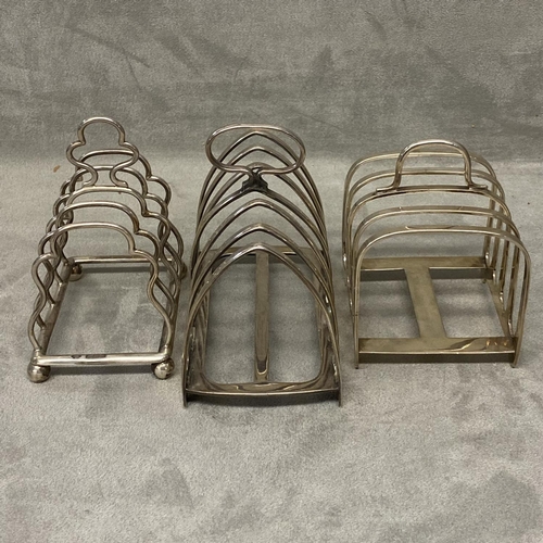 36 - Three Sterling silver toast racks, two four division and one six division 310 gn, various makers and... 