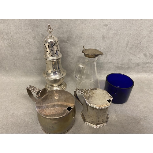 48 - A collection of Sterling siler items to include 2 mustards, a toddy  decanter sugar shaker various d... 