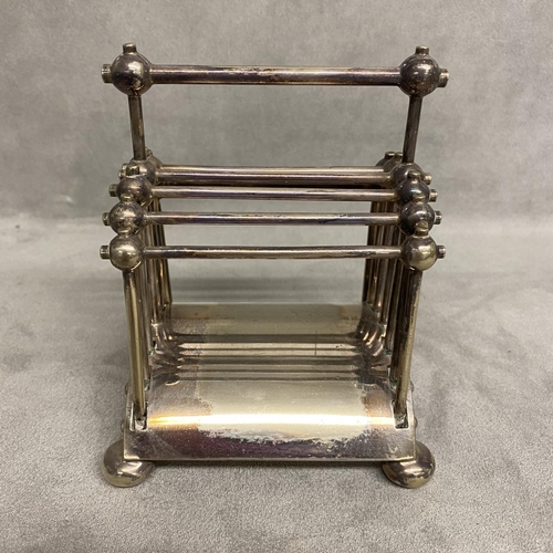 5 - A Hukin and Heath electroplated folded toast rack, designed by Dr Christopher Dresser Model number 2... 