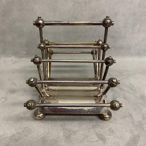 5 - A Hukin and Heath electroplated folded toast rack, designed by Dr Christopher Dresser Model number 2... 