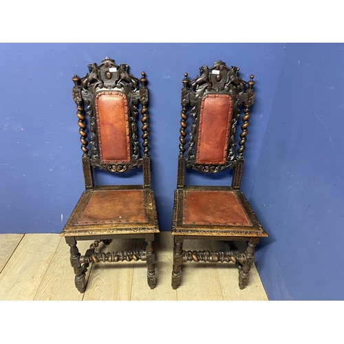 622 - Pair of carved gothic style oak hall chairs with red leather inset seats. Damage to one, see images