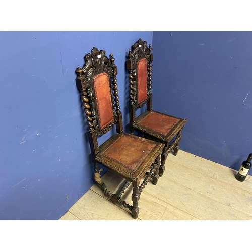 622 - Pair of carved gothic style oak hall chairs with red leather inset seats. Damage to one, see images