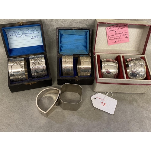 75 - A collection of Sterling silver napkin rings to include 3 boxed pairs and 3 single examples, various... 