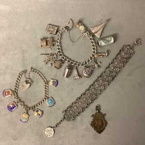 123 - Jewellery to include: A white metal coin bracelet (not hallmarked), and Sterling Silver charm bracel... 