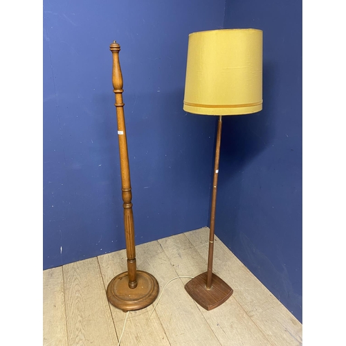 209 - Two wooden lamps, a turned oak example and one othe 148cm approx