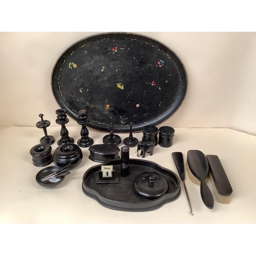 211 - A black oval decorative papier mache tray together with turned ebonised wooden items. Tray 55 x 40cm