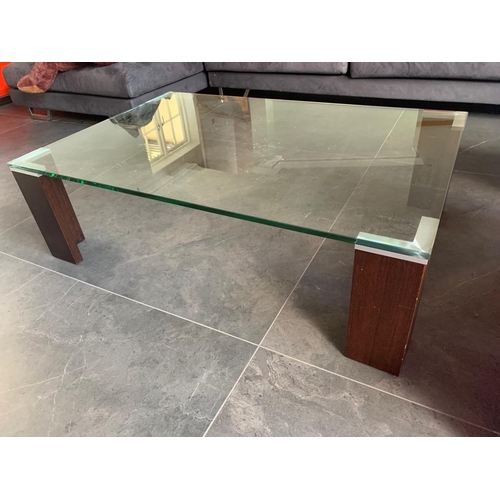 458 - Designer Manhattan coffee table, with glass top raised on four Dark Oak legs

H 45
W 140
D 75