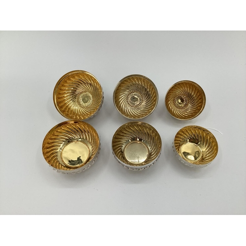 10 - Set of 3 graduated white metal lidded bowls, with reeded decoration flower finials, gilt interior, s... 