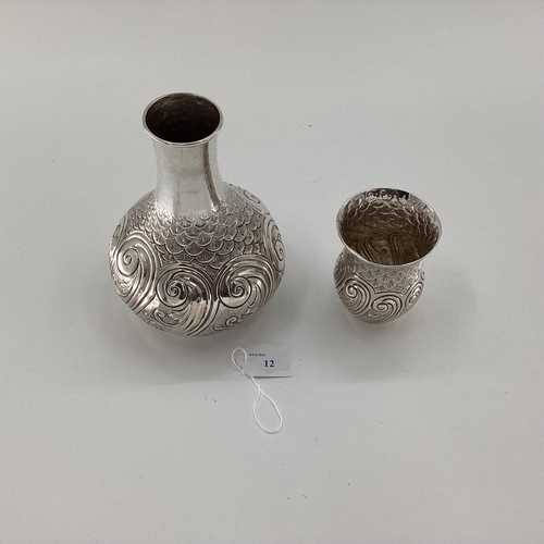 12 - A white metal baluster shaped water flask with swirling and chased decoration, matching goblet, mark... 