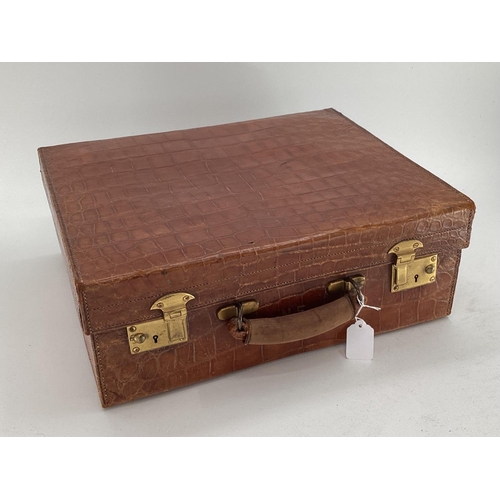 138 - Early C20th crocodile skin ladies travel vanity case, with near complete fitted sterling silver topp... 