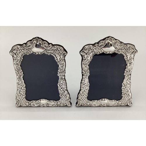 14 - Pair of Sterling silver desk top easel back picture frames, with floral decoration, Sheffield 1922; ... 