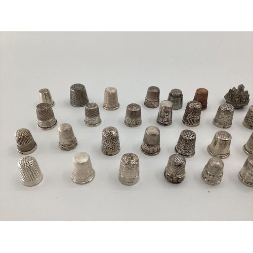 142 - Large collection of mainly sterling silver and unmarked white metal thimbles, various makers and dat... 