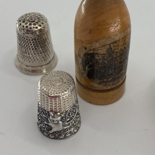 143 - 3 Sterling silver boxed thimbles, together with one loose sterling silver item, wooden etc