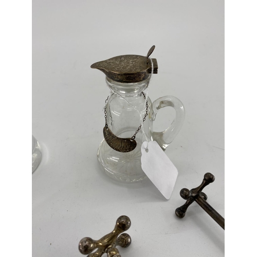 145 - A hallmarked silver glass whisky noggin, another glass jar and knife rests and hallmarked silver sma... 