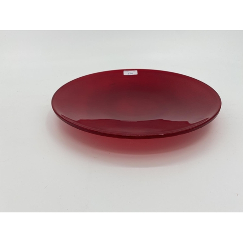 174 - A Nonfoux circular red glass plate, etched and dated to rim 86, approx 31cm diameter