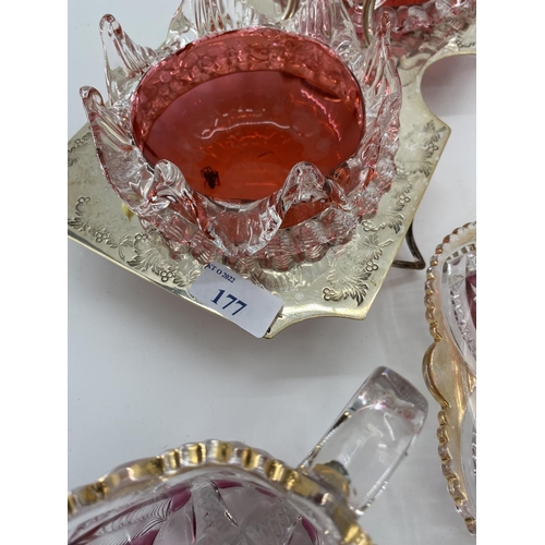 177 - Two cranberry glass and white metal sweet meat serving platters, and two flash cut glass jugs and po... 