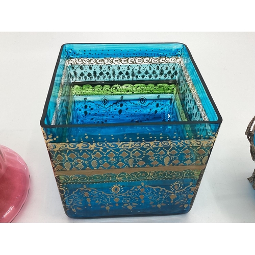 178 - A collection of C20th glass to include two metal topped cranberry glass biscuit tin, metal topped en... 