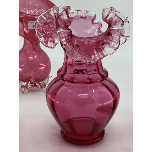 189 - A collection of cranberry glass items to include Jack in a Pulpit vase, lidded bowl, a pair of vases... 