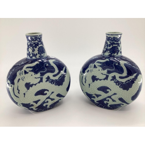 237 - Pair of C20th blue and white Moonflask vases, decorated dragons to body