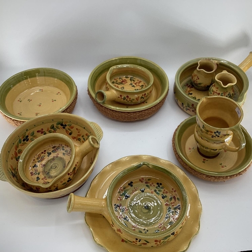 239 - A quantity of decorative rustic Provenance pottery, in yellow and green ground decorated olives and ... 