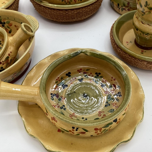 239 - A quantity of decorative rustic Provenance pottery, in yellow and green ground decorated olives and ... 