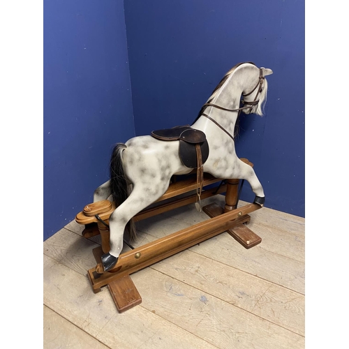 257 - A C20th Rocking horse, grey dappled, on a swing base, and  bears label Horse Play, Broad Hempston, D... 