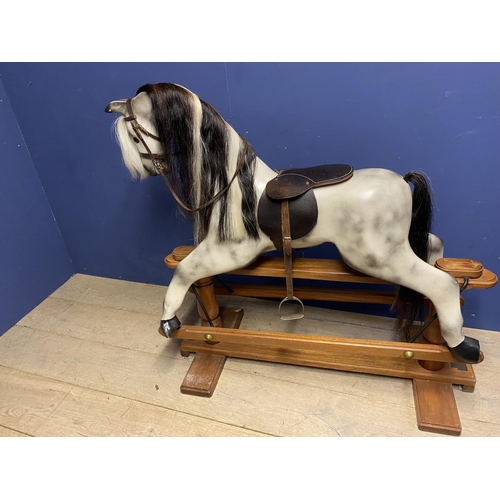 257 - A C20th Rocking horse, grey dappled, on a swing base, and  bears label Horse Play, Broad Hempston, D... 