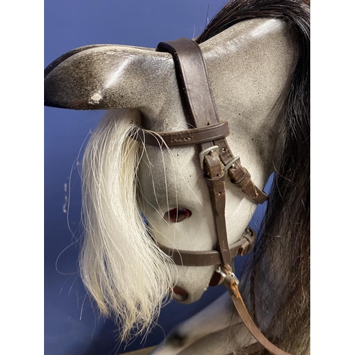 257 - A C20th Rocking horse, grey dappled, on a swing base, and  bears label Horse Play, Broad Hempston, D... 