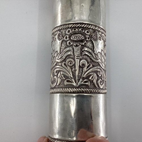 34 - A Middle Eastern style white metal prayer scroll with raised flora and fauna decoration, 30cm, 465gr... 