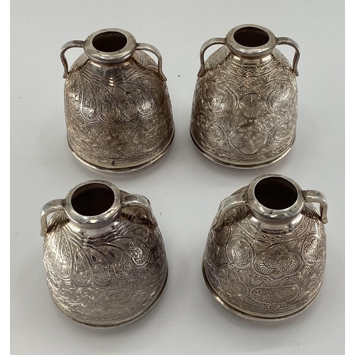 4 - Two pairs of Egyptian white metal decorative water urns, with chased decoration, loop handles and ha... 