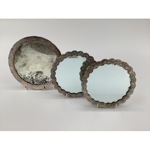 44 - A pair of unmarked white metal circular dressing table mirrors, together with an Egyptian silver exa... 