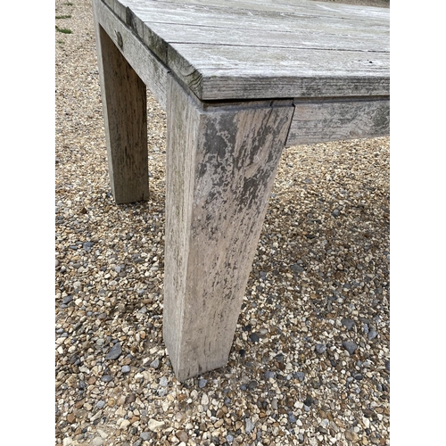 501 - A good solid heavy rustic teak garden plank top table., with parasol hole, general wear and some wea... 