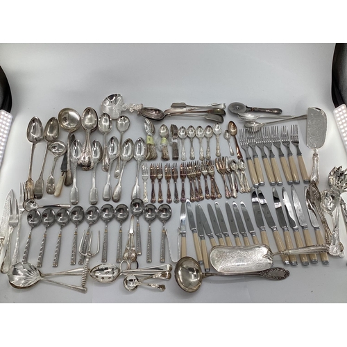 54 - A large collection of plated flatware and kitchen utensils